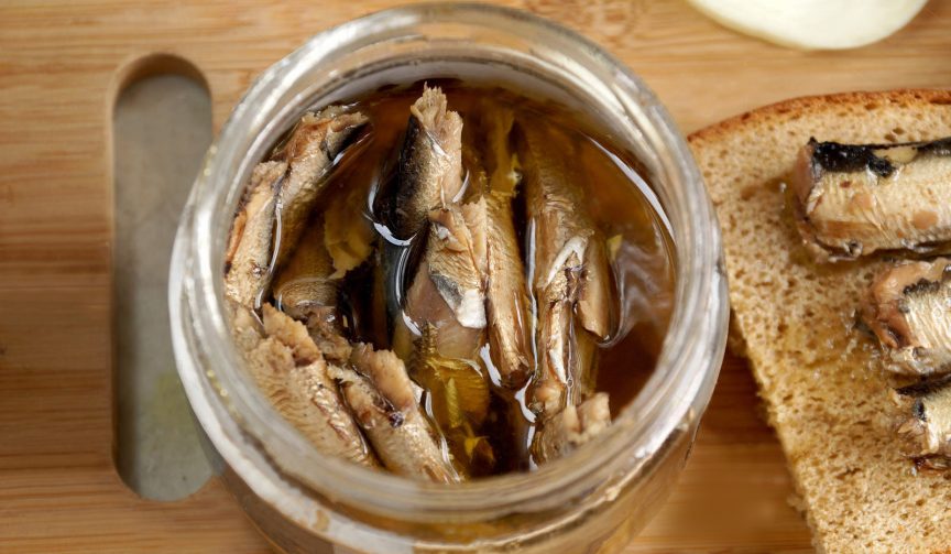 Fish sprats canned food in oil in a glass jar